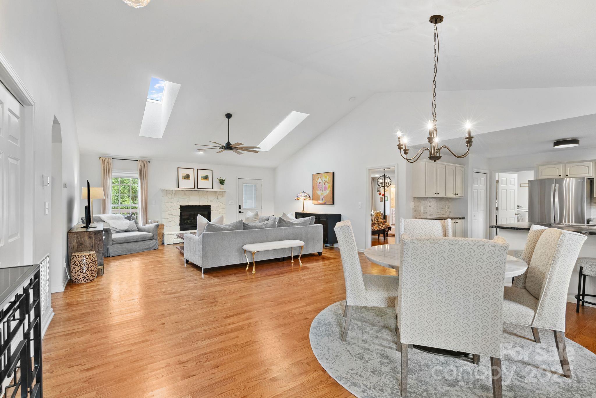 6 Sayles Town Road Fairview, NC 28730 - Photo 5 of 43 a living room with furniture a fireplace and a chandelier