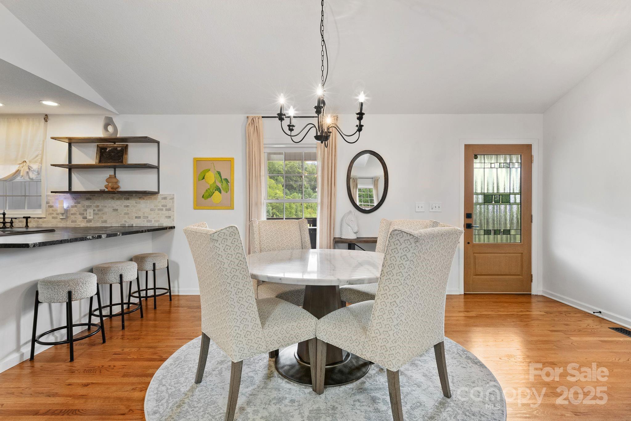 6 Sayles Town Road Fairview, NC 28730 - Photo 6 of 43 a view of a dining room with furniture a chandelier and wooden floor