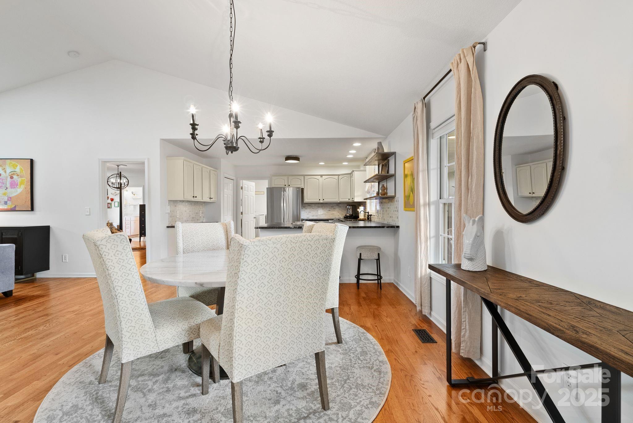 6 Sayles Town Road Fairview, NC 28730 - Photo 8 of 43 a dining room with furniture a chandelier and wooden floor