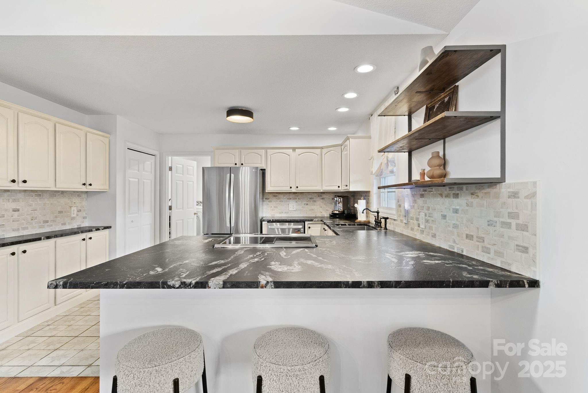 6 Sayles Town Road Fairview, NC 28730 - Photo 9 of 43 a view of a kitchen with kitchen island a sink stainless steel appliances and cabinets