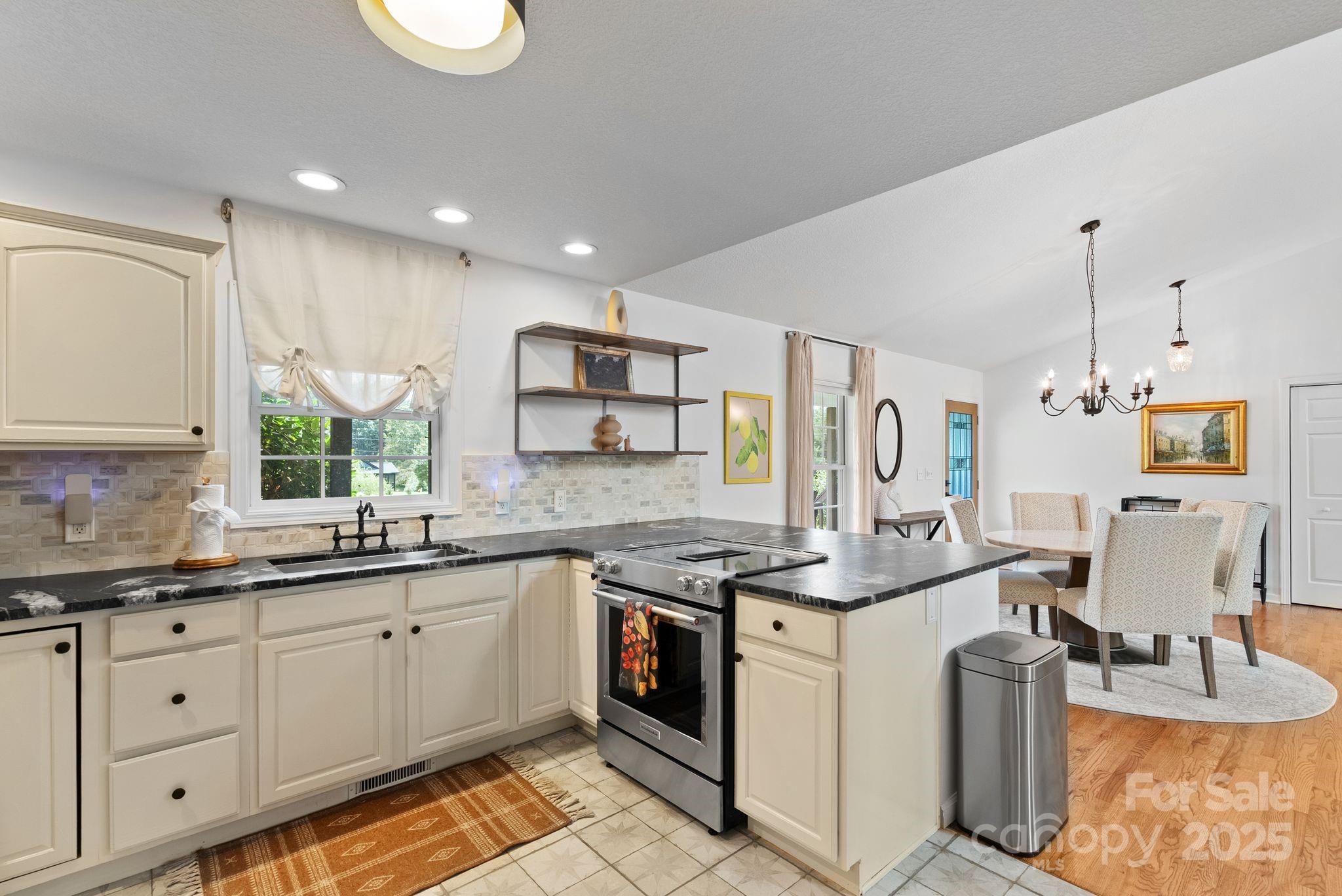 6 Sayles Town Road Fairview, NC 28730 - Photo 10 of 43 a kitchen with a sink stove and cabinets