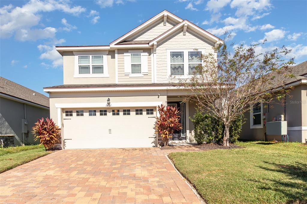 a front view of a house with a yard and garage