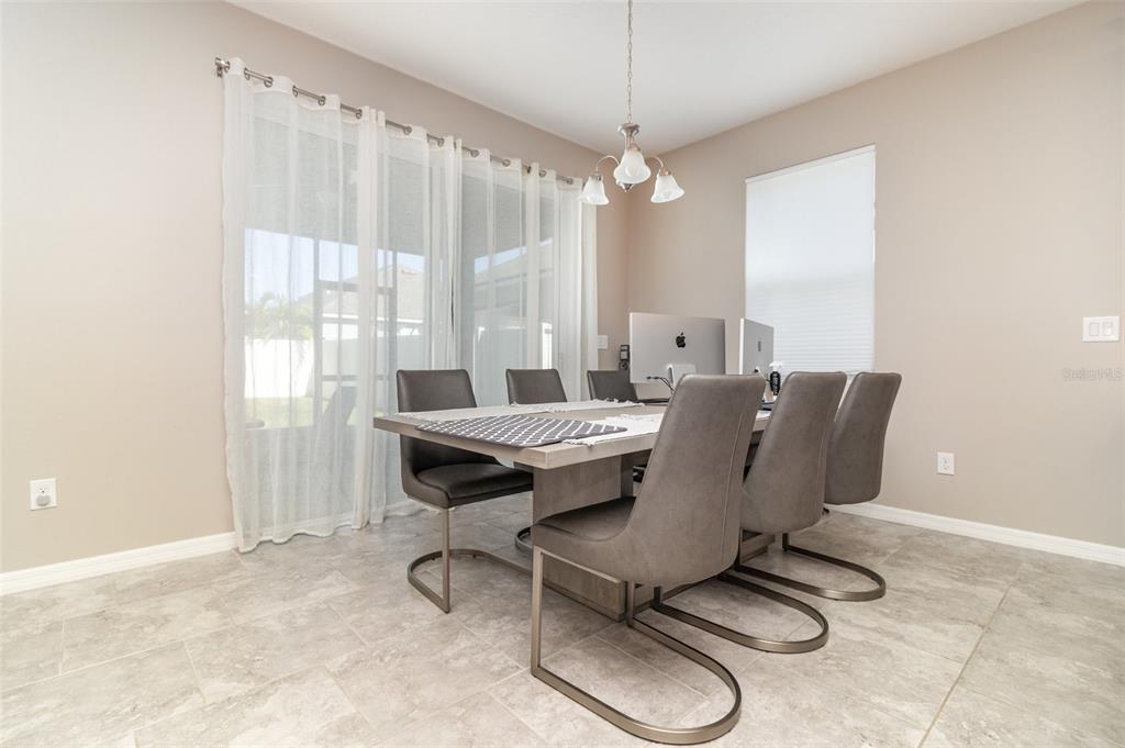 2461 Avian Loop Kissimmee, FL 34741 - Photo 11 of 36 a living room with furniture a chandelier and a window