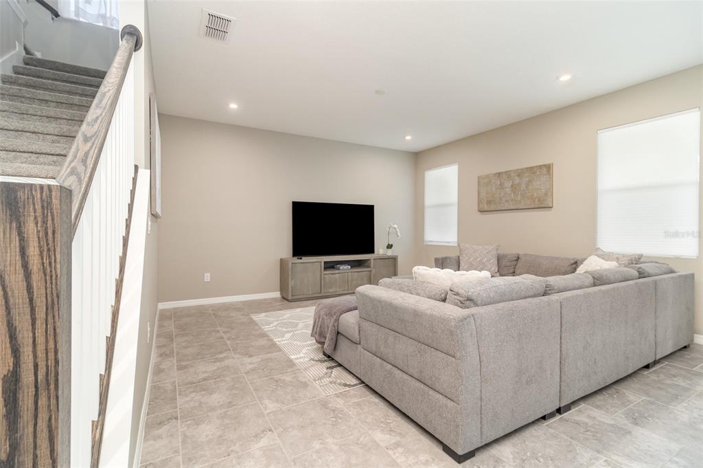 2461 Avian Loop Kissimmee, FL 34741 - Photo 12 of 36 a living room with furniture and a flat screen tv
