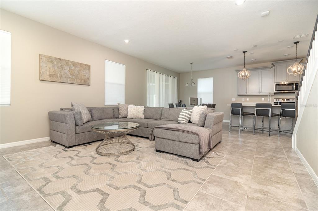 2461 Avian Loop Kissimmee, FL 34741 - Photo 13 of 36 a living room with furniture and kitchen view