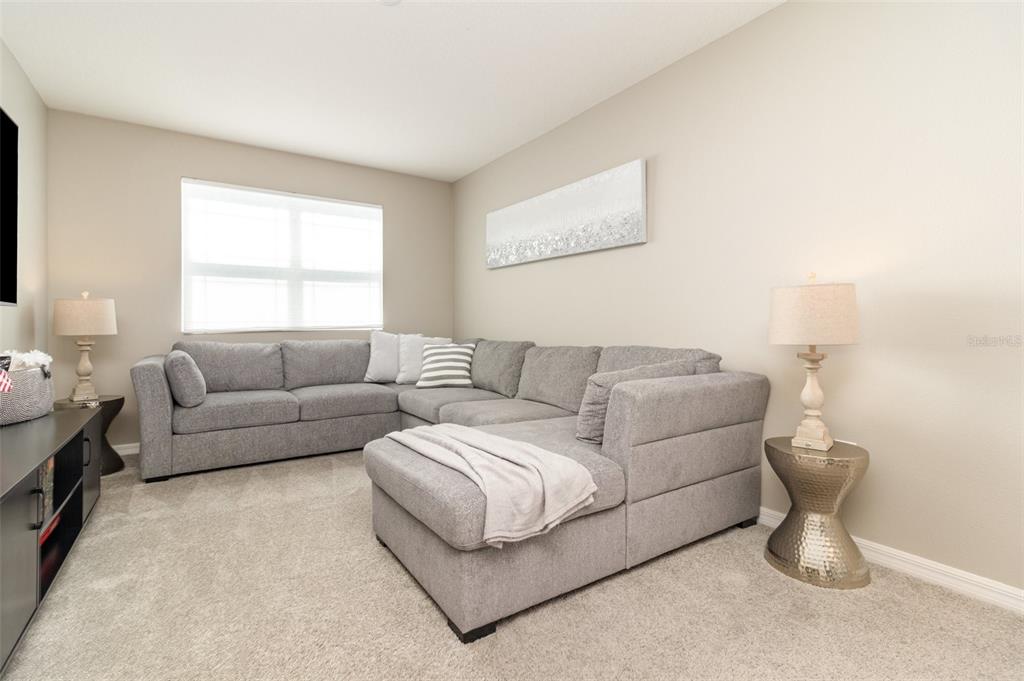 2461 Avian Loop Kissimmee, FL 34741 - Photo 14 of 36 a living room with furniture and a window