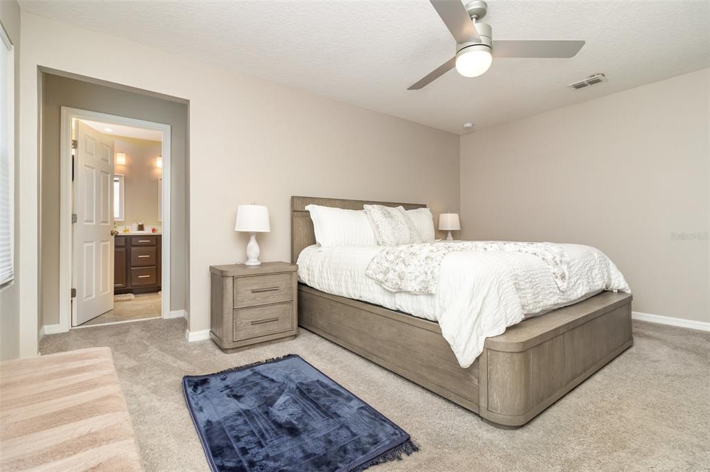 2461 Avian Loop Kissimmee, FL 34741 - Photo 16 of 36 a large bedroom with a bed and cabinets