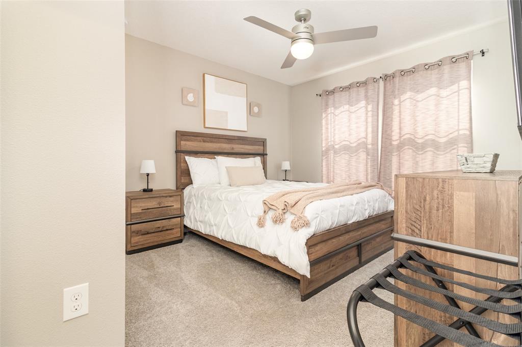 2461 Avian Loop Kissimmee, FL 34741 - Photo 19 of 36 a bedroom with a bed and window