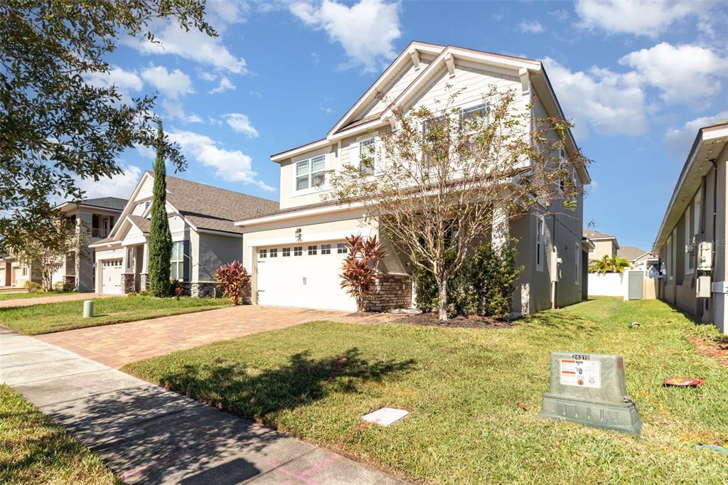 2461 Avian Loop Kissimmee, FL 34741 - Photo 2 of 36 a view of a yard with yellow house
