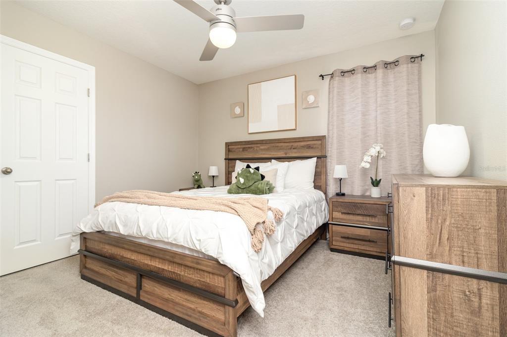 2461 Avian Loop Kissimmee, FL 34741 - Photo 21 of 36 a bedroom with a bed and window