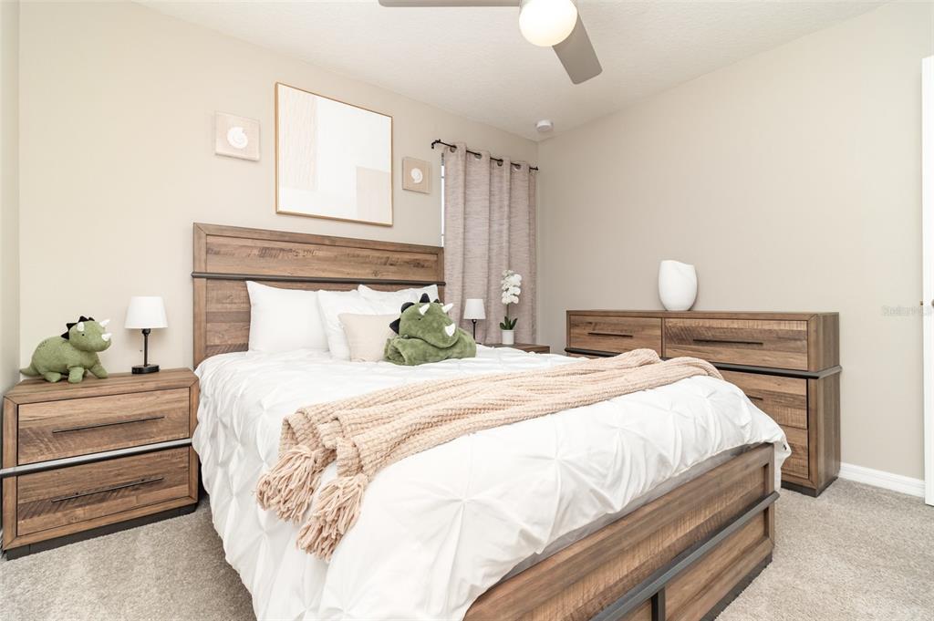 2461 Avian Loop Kissimmee, FL 34741 - Photo 22 of 36 a bedroom with bed and wooden floor