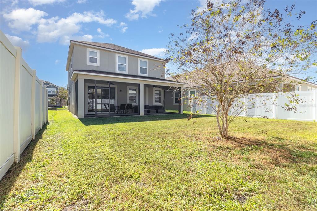 2461 Avian Loop Kissimmee, FL 34741 - Photo 26 of 36 a view of a house with a yard