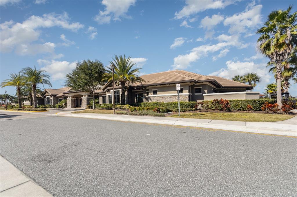 2461 Avian Loop Kissimmee, FL 34741 - Photo 29 of 36 a front view of house with a garden and trees