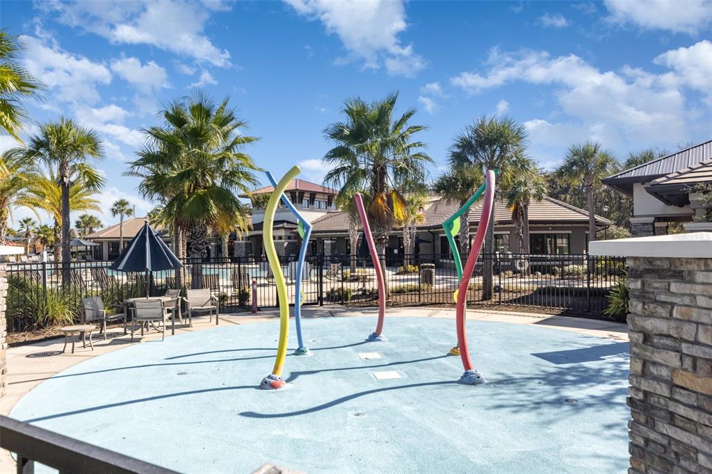 2461 Avian Loop Kissimmee, FL 34741 - Photo 34 of 36 a building with palm tree in front of it