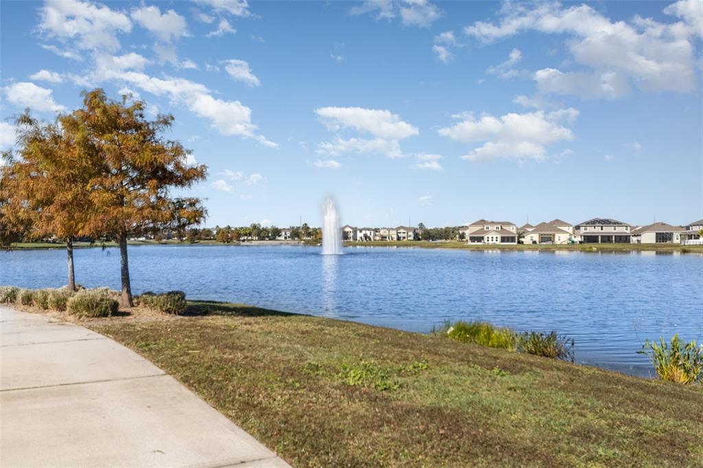 2461 Avian Loop Kissimmee, FL 34741 - Photo 36 of 36 a view of a lake with houses in the back
