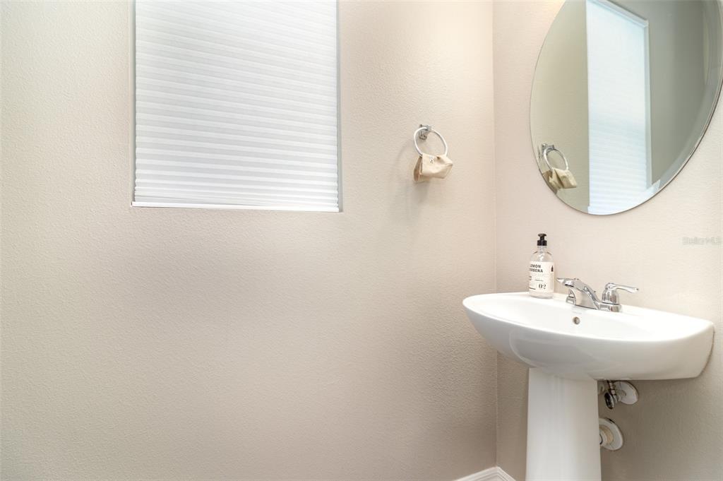 2461 Avian Loop Kissimmee, FL 34741 - Photo 5 of 36 a bathroom with a sink and a mirror