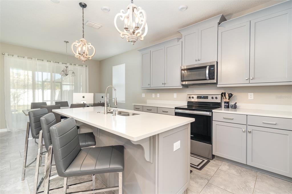 2461 Avian Loop Kissimmee, FL 34741 - Photo 7 of 36 a kitchen with a stove window and cabinets