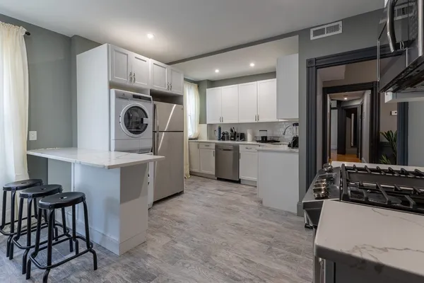 a kitchen with a stove a sink and a refrigerator