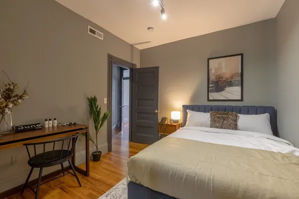 a bedroom with a bed and a table in it