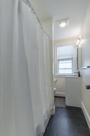 a bathroom with a sink a toilet and a mirror