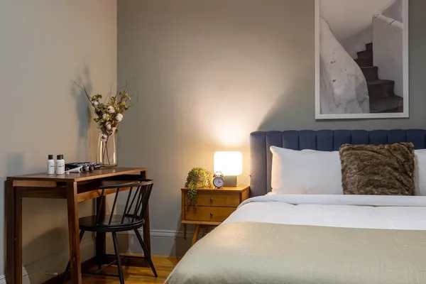 a bedroom with a bed and a potted plant