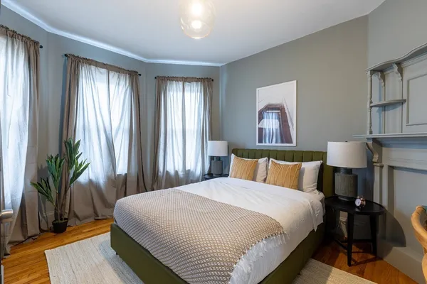 a bedroom with bed and a large window