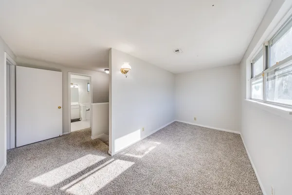 a view of a big room with windows and bathroom