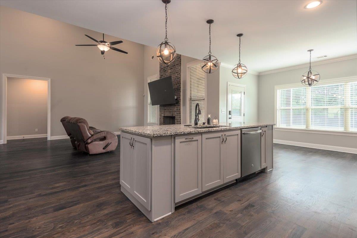 3328 Straw Bridge Road Olive Branch, MS 38654 - Photo 16 of 28 Central kitchen island with light gray cabinetry, built-in dishwasher, and granite-look countertop
