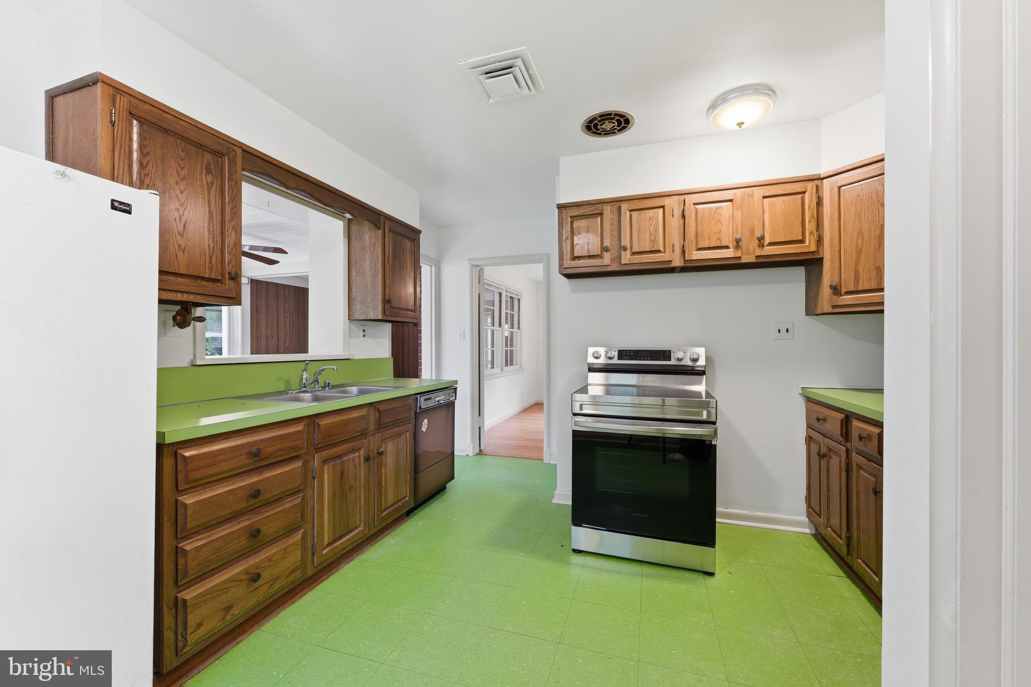 228 Northwest Terrace Silver Spring, MD 20901 - Photo 13 of 70 a kitchen with stainless steel appliances granite countertop a stove and a refrigerator