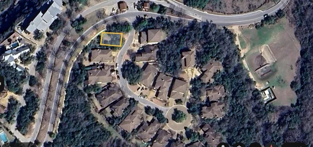 a view of a lake with a big yard and potted plants