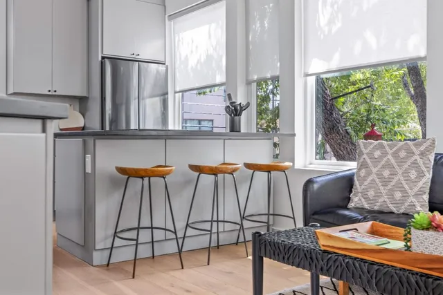 a kitchen with granite countertop white cabinets and white appliances