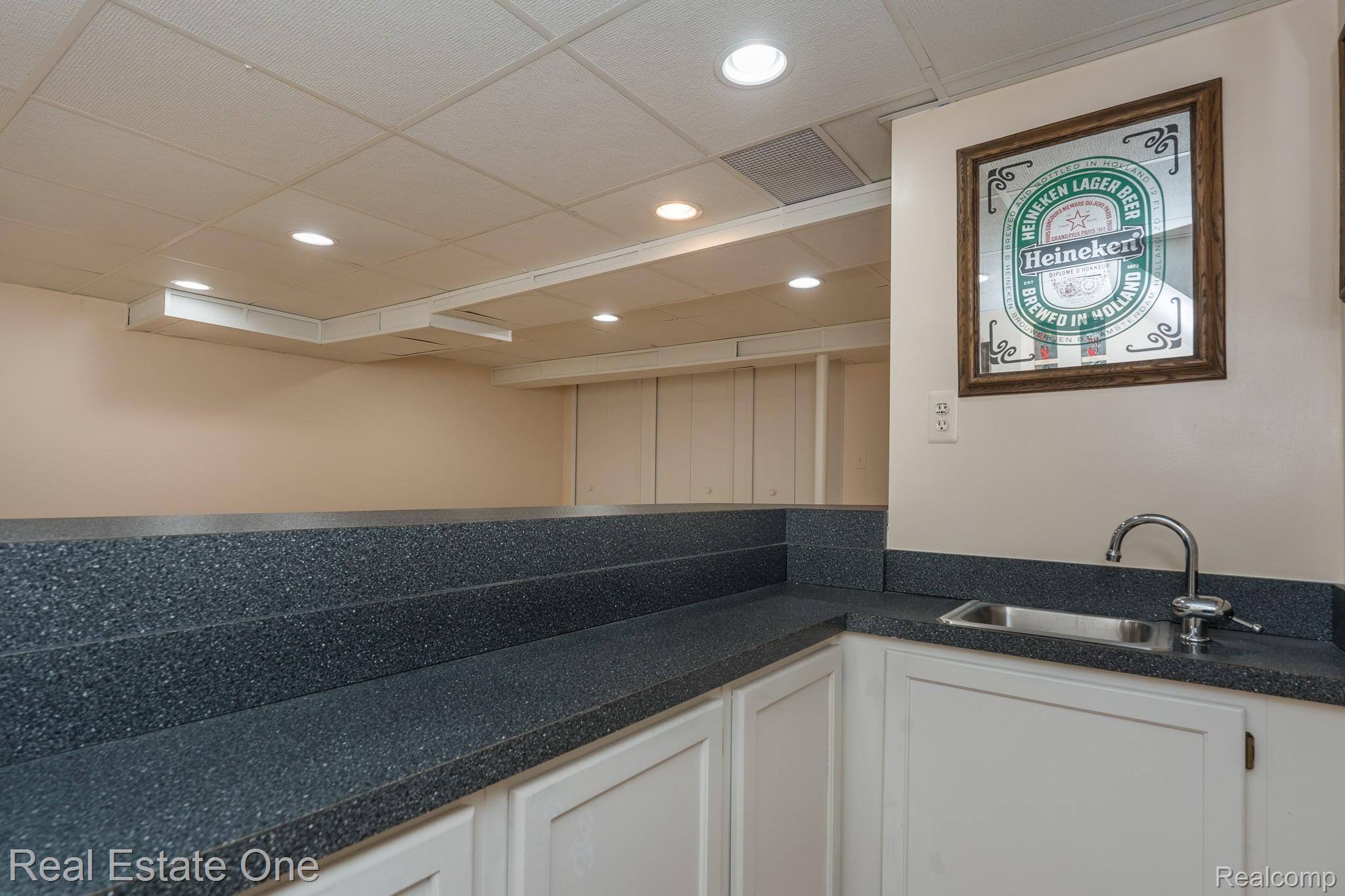 327 Silvervale Drive Rochester, MI 48309 - Photo 32 of 43 WET BAR IN THE FINISHED BASEMENT: LOTS OF EXTRA USABLE SPACE THAT IS NICELY FINISHED INCLUDES ANOTHER 26 X 11 REC ROOM AND A 1/2 BATH.