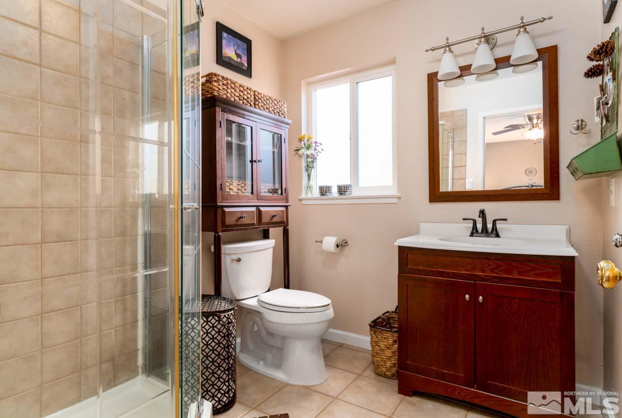 655 Amber Circle Reno, NV 89509 - Photo 14 of 31 a bathroom with a granite countertop sink toilet and shower