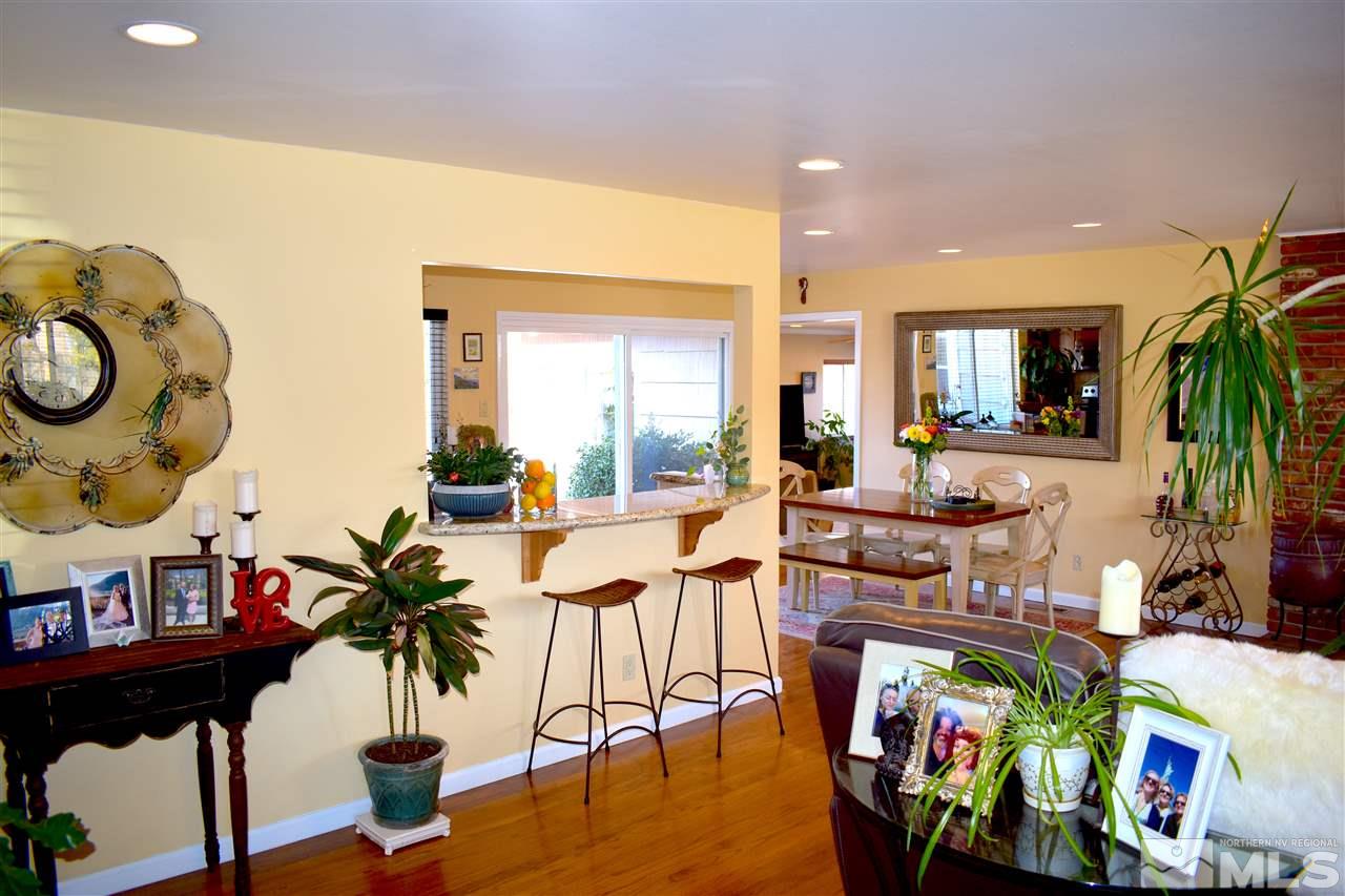 655 Amber Circle Reno, NV 89509 - Photo 2 of 31 a living room with furniture and a floor to ceiling window