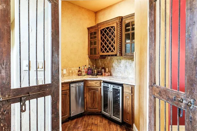 an empty room with windows closet and chandelier fan