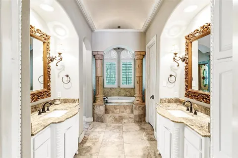 a living room with pool table flat screen tv and windows