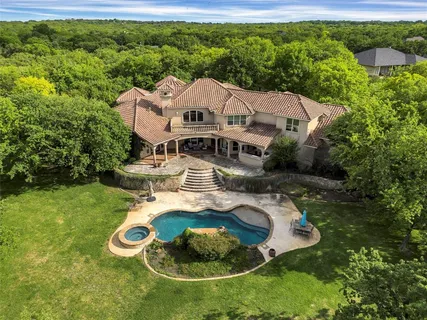 an aerial view of a house with garden space and street view