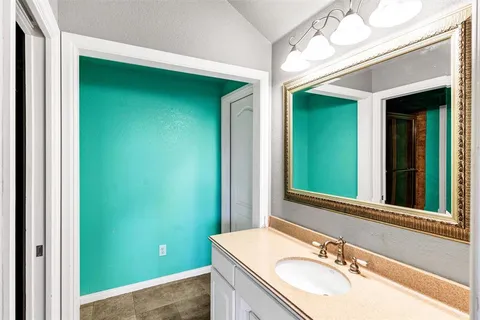 a kitchen with a sink a washer and dryer next to a window