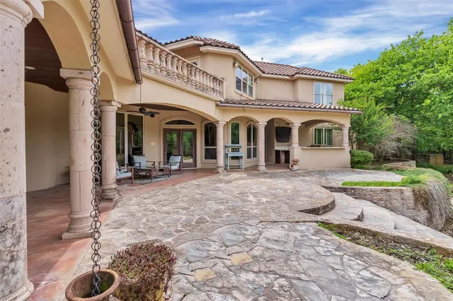 a view of a white house with a outdoor space and garden