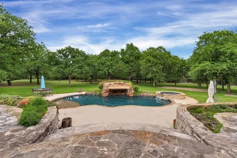 a view of a swimming pool with a yard