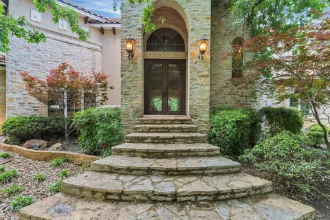 a backyard of a house with table and chairs