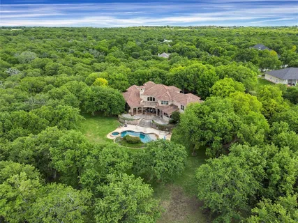 an aerial view of a house with garden space and street view