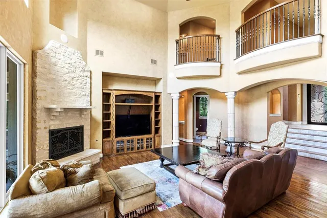 a living room with furniture fireplace and flat screen tv