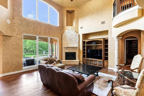 a living room with furniture fireplace and a large window