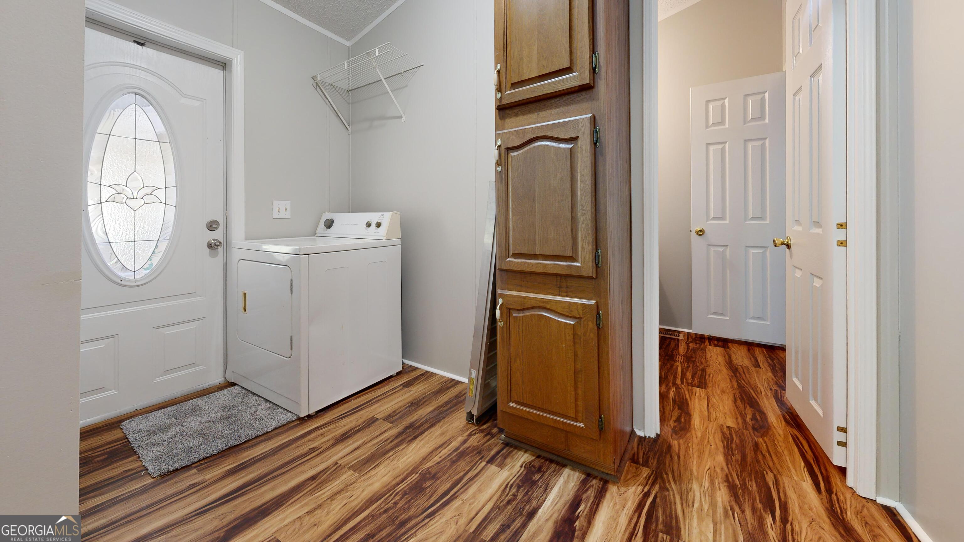 6498 Central Avenue Waycross, GA 31503 - Photo 9 of 20 a view of a storage and utility room with wooden floor