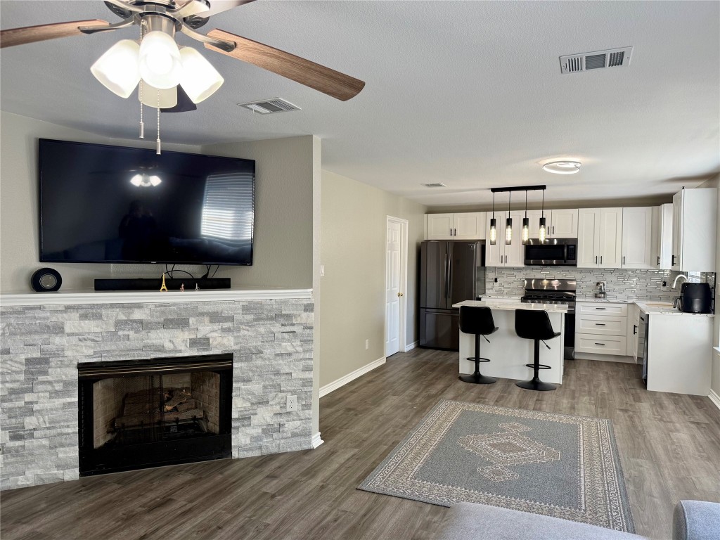 1002 Port Daniel Drive Leander, TX 78641 - Photo 12 of 12 a living room with furniture a fireplace and a flat screen tv
