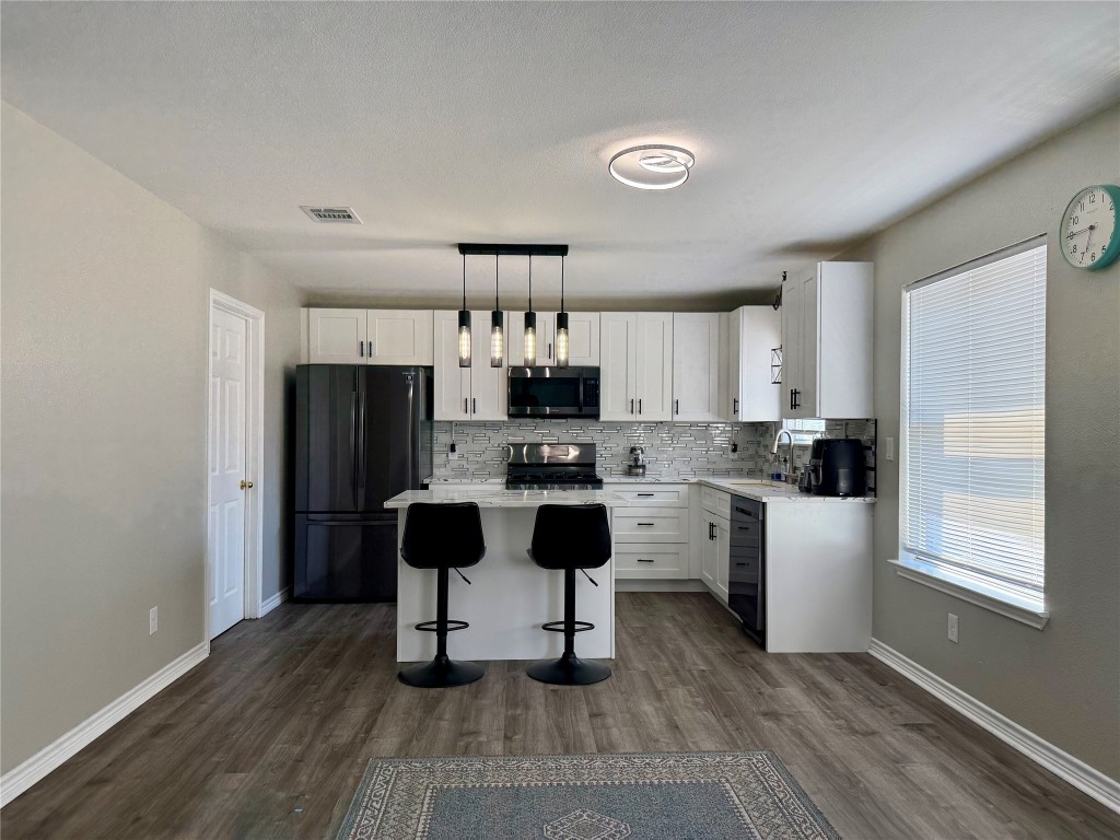 1002 Port Daniel Drive Leander, TX 78641 - Photo 2 of 12 a kitchen with a sink cabinets and refrigerator