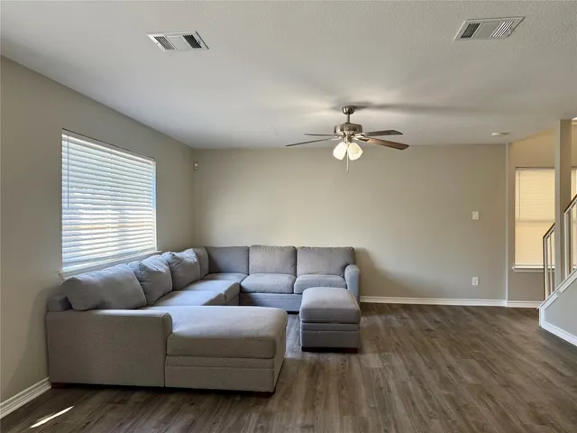 a kitchen with stainless steel appliances granite countertop a sink a stove a refrigerator and cabinets
