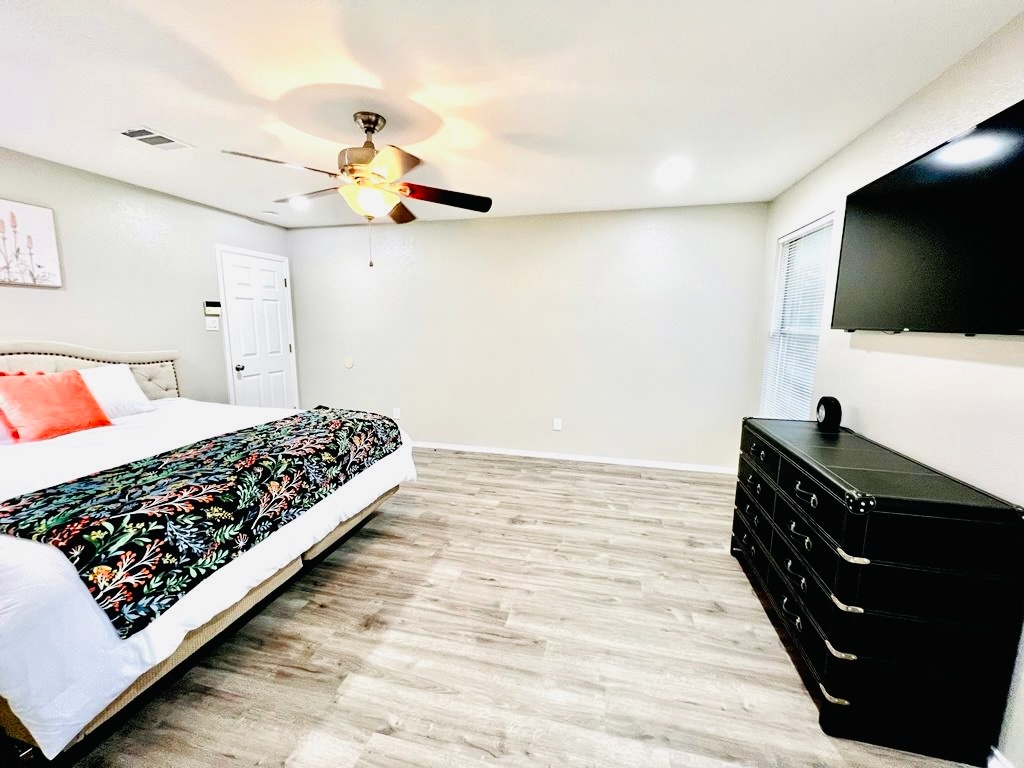 1002 Port Daniel Drive Leander, TX 78641 - Photo 6 of 12 a bedroom with a bed and flat screen tv