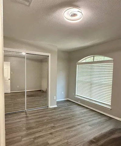 a bedroom with a bed and flat screen tv